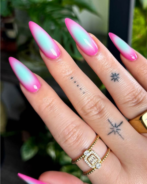 Long pointytip acrylic nails with light blue aura that fades into a hot pink exterior.