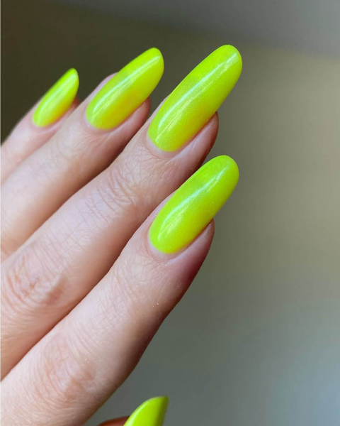 Long roundedtip neon yellow acrylic nails pointed up.