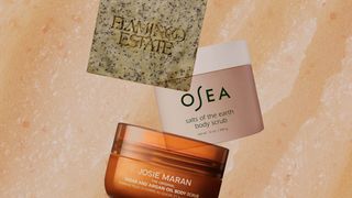 A collage of Flamingo Estate Josie Maran and Osea body scrubs and bars on a closeup texture shot of peachtinted body scrub