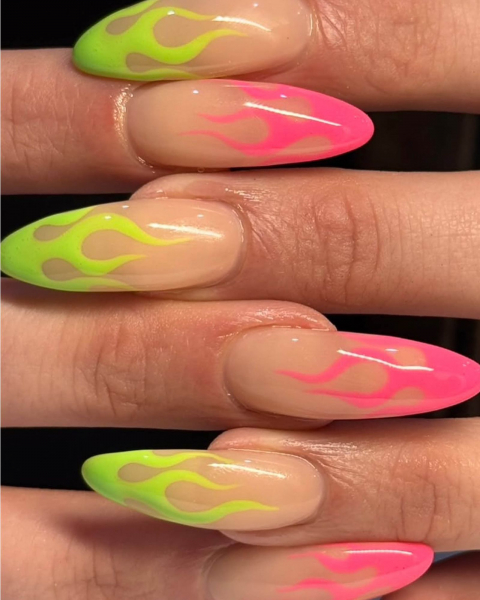 Alternating neon yellowishgreen and pink flame acrylic nails on nude base.