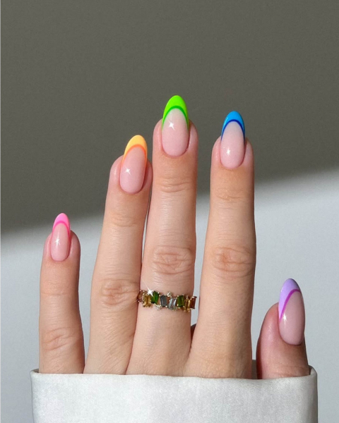 Neon rainbowstriped French tip nails with a nude base coat.