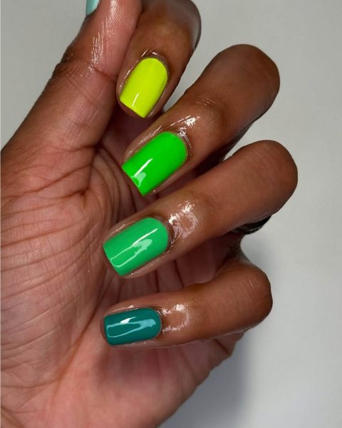 Multishade green nails with the lightest green on the top section and the darkest on the bottom of the nail stack.